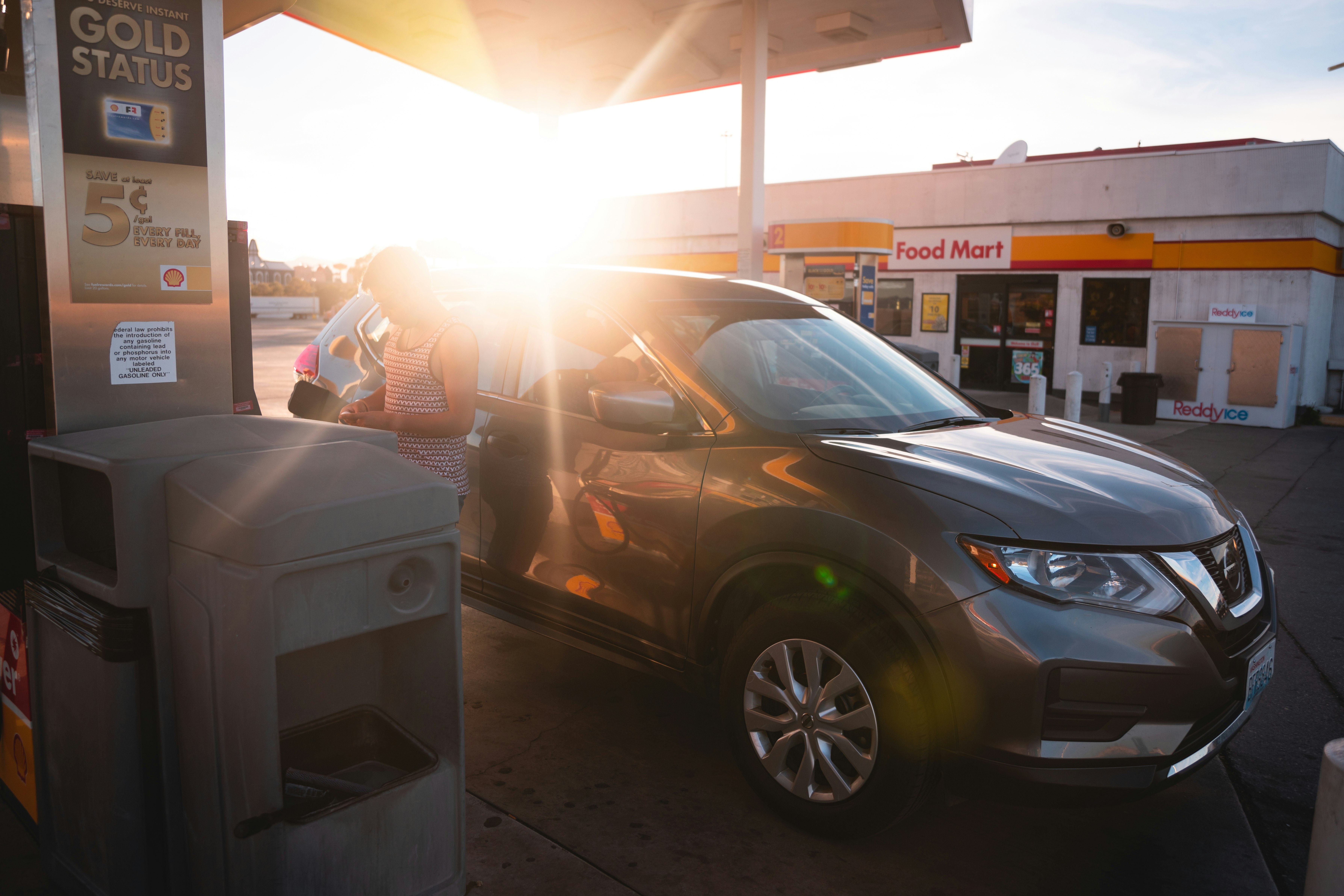 black honda sedan parked near white and gray food stall